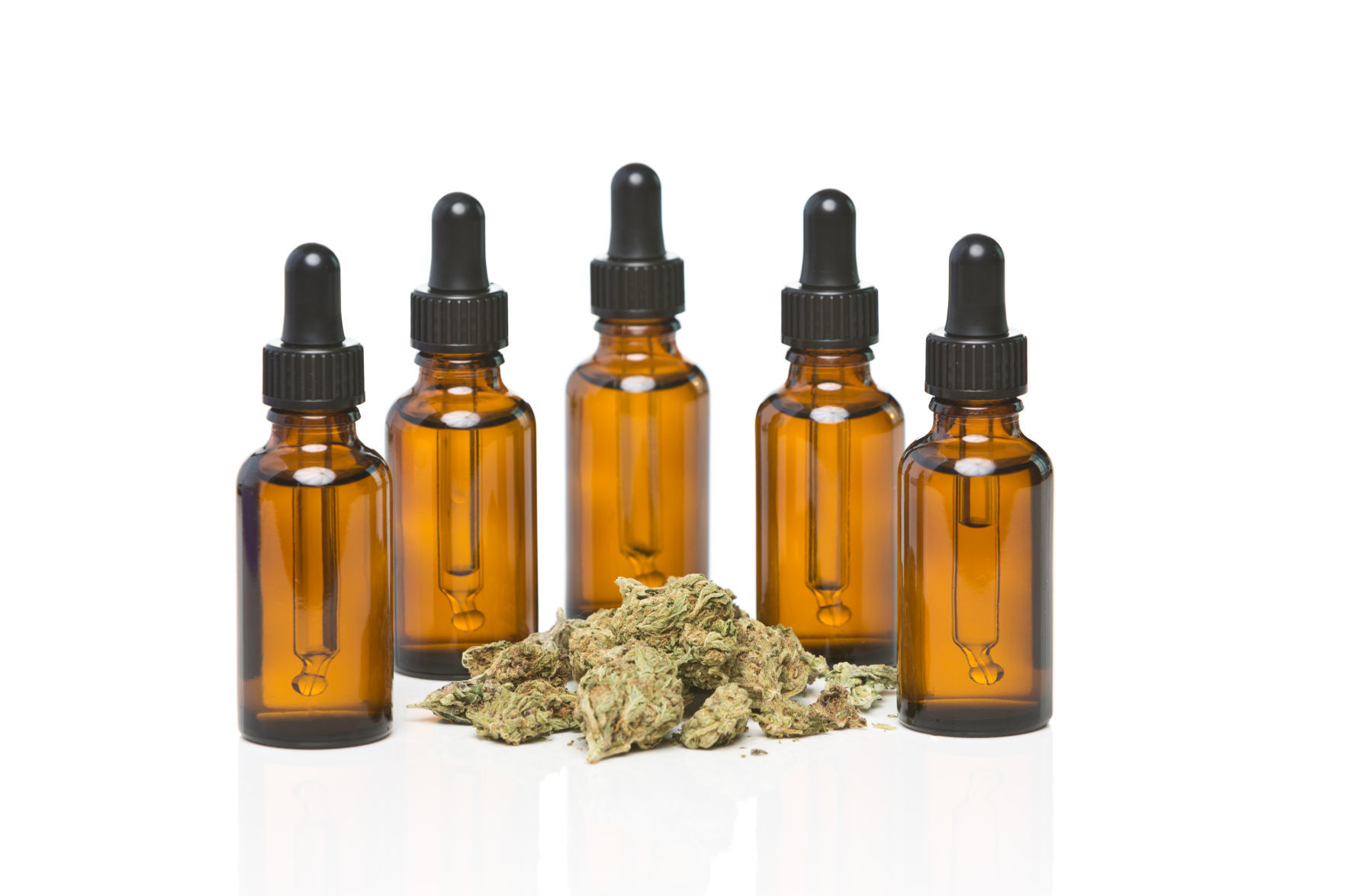 Five dropper bottles surrounding a pile of cannabis