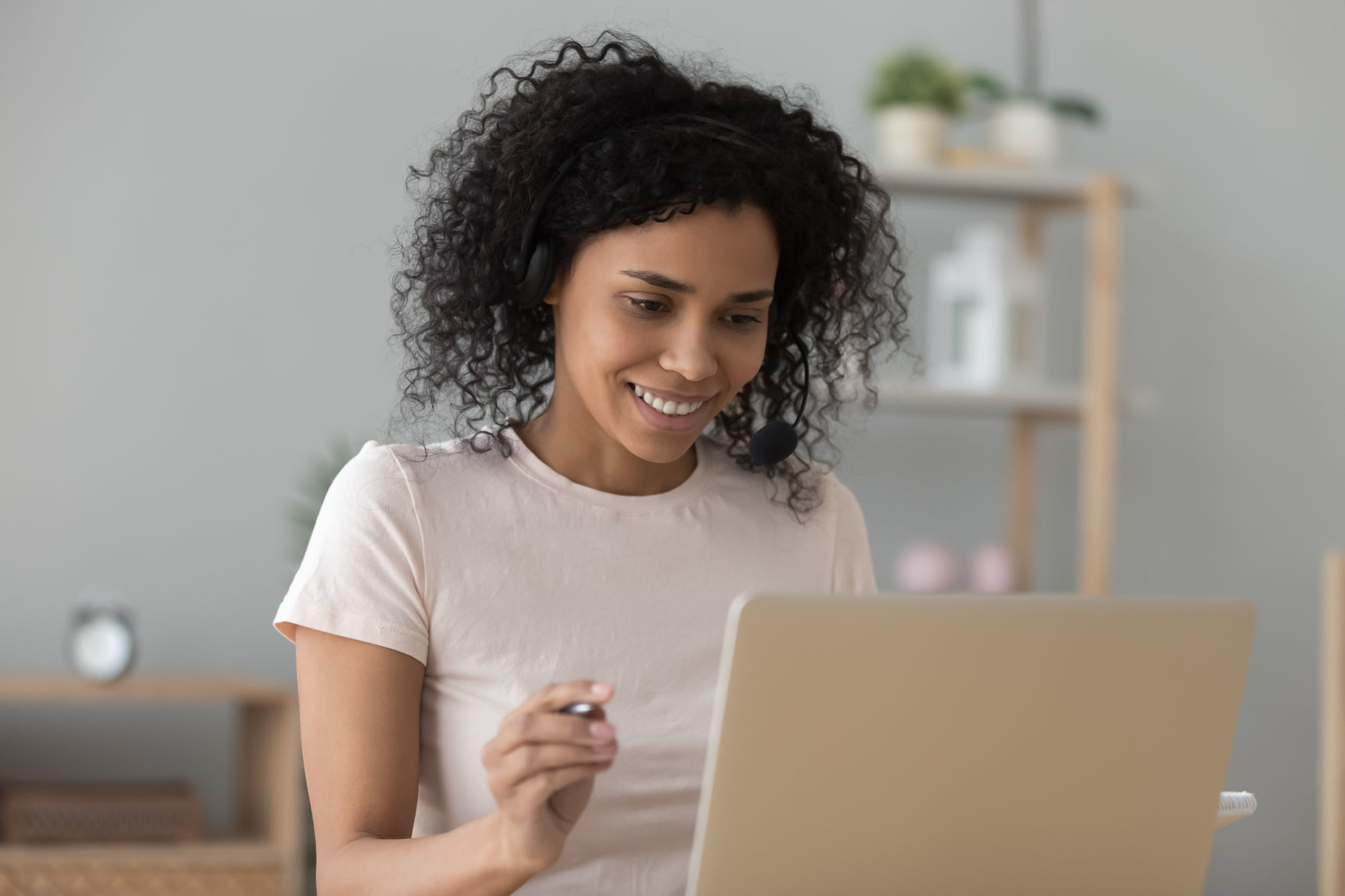 African woman looking at pc screen do task learning online