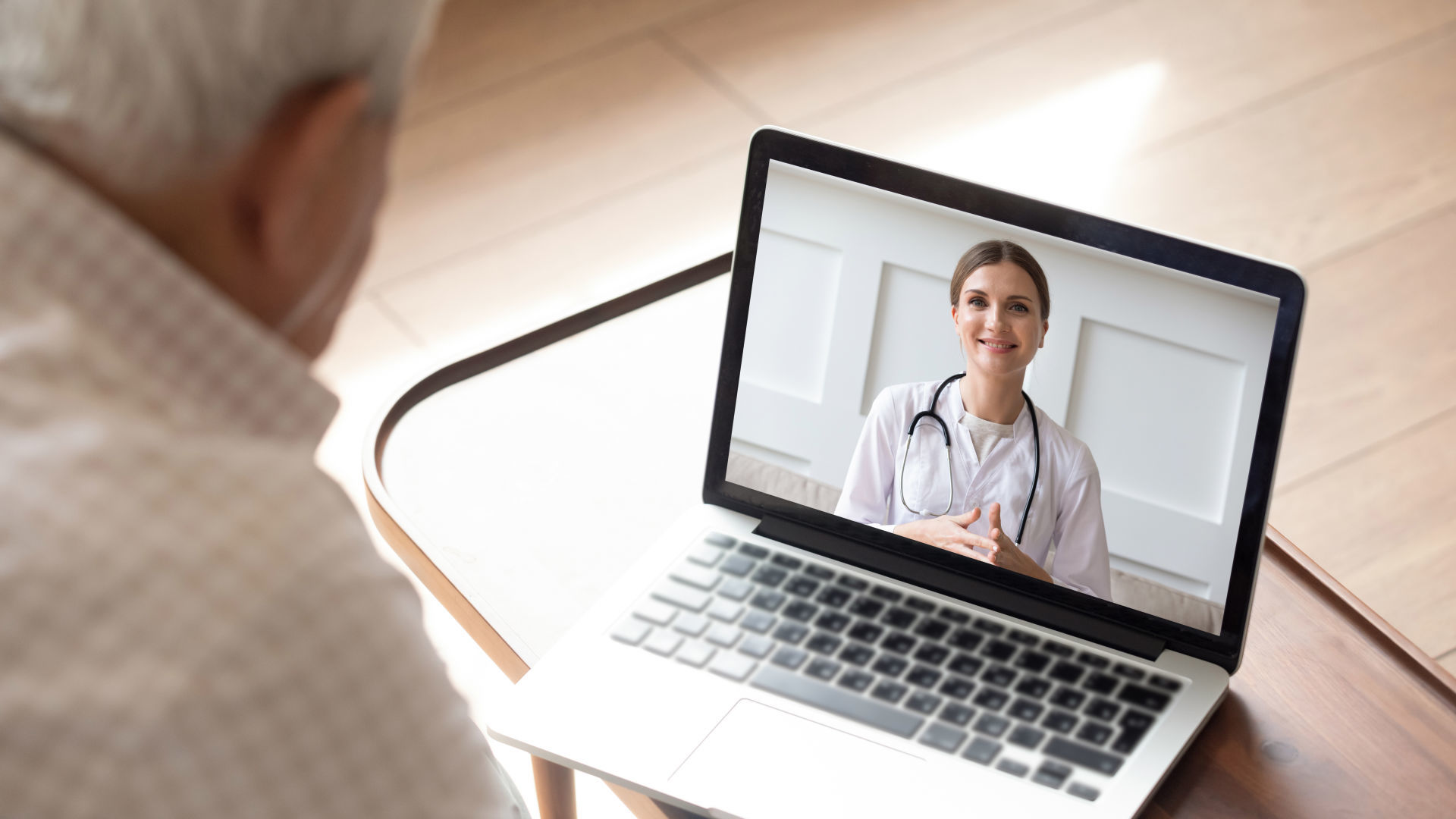 Elderly man having online video consultation with doctor