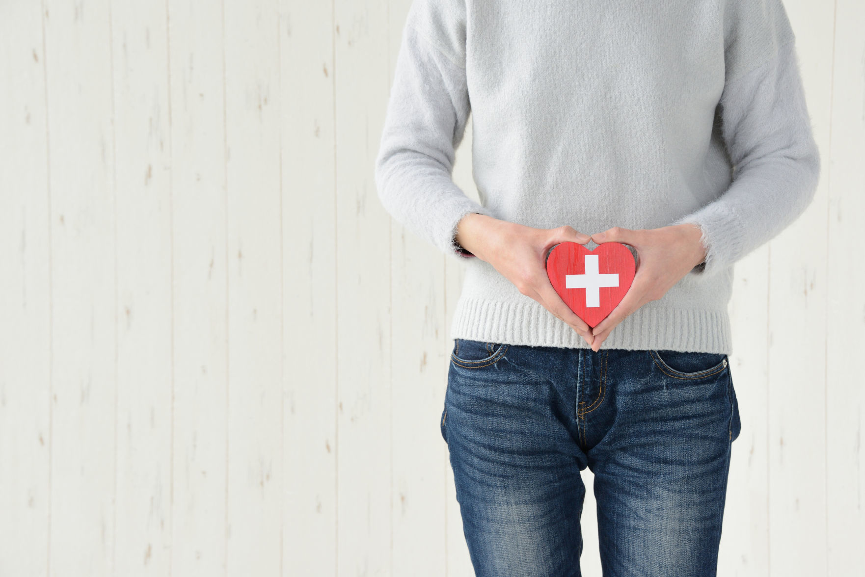 Woman having heart object on lower abdomen
