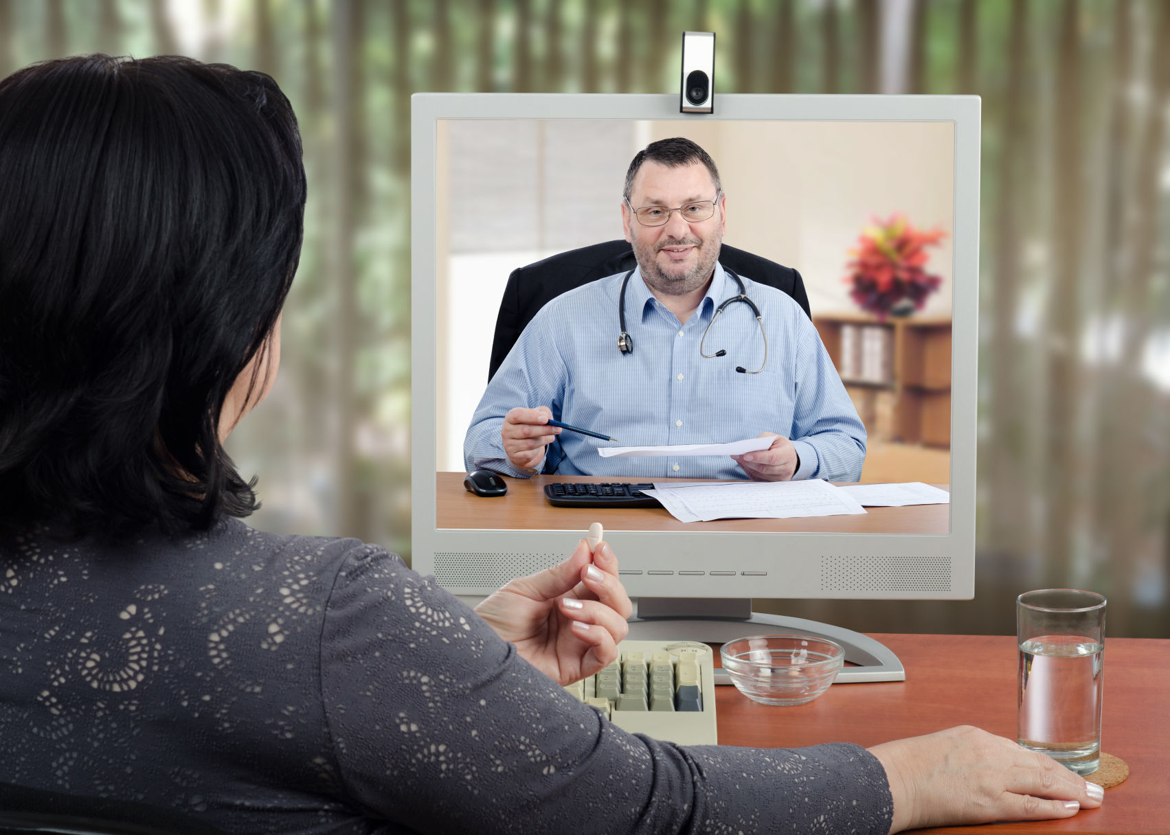 Doctor reviews medical laboratory results with online patient