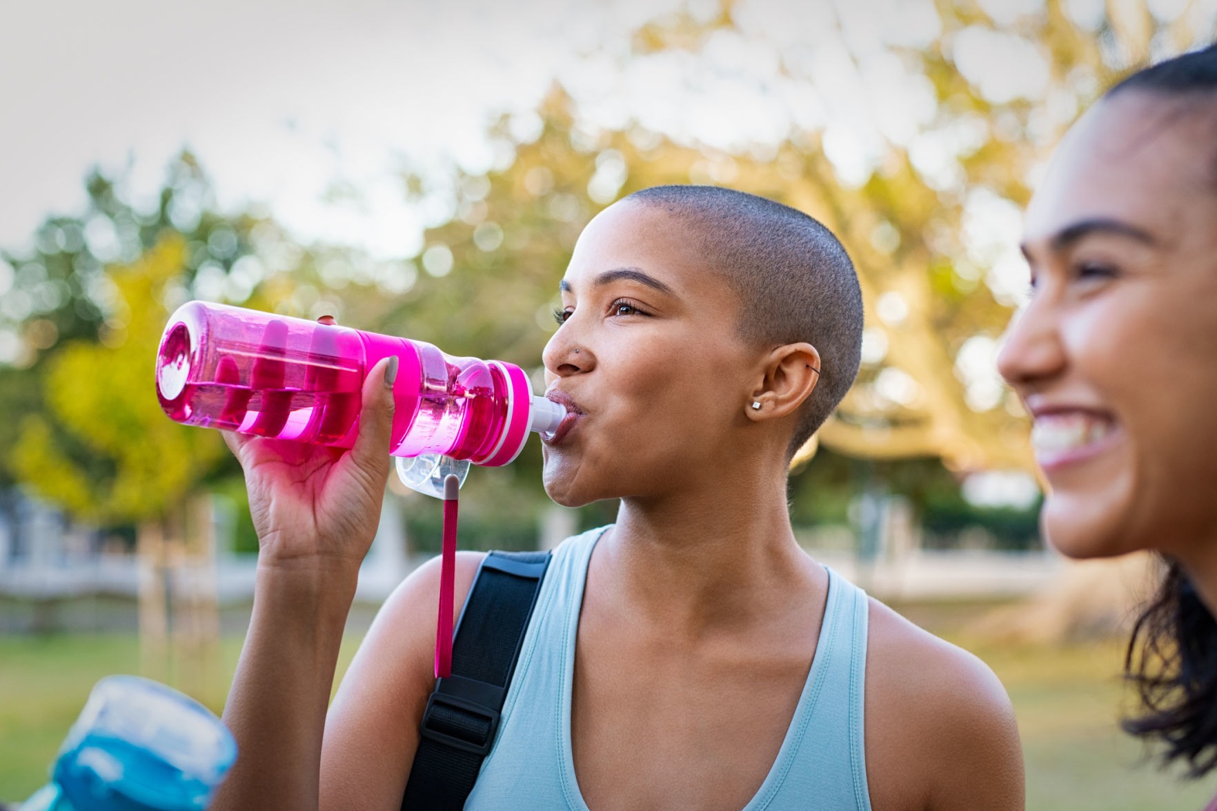 Woman drinking water after exercise